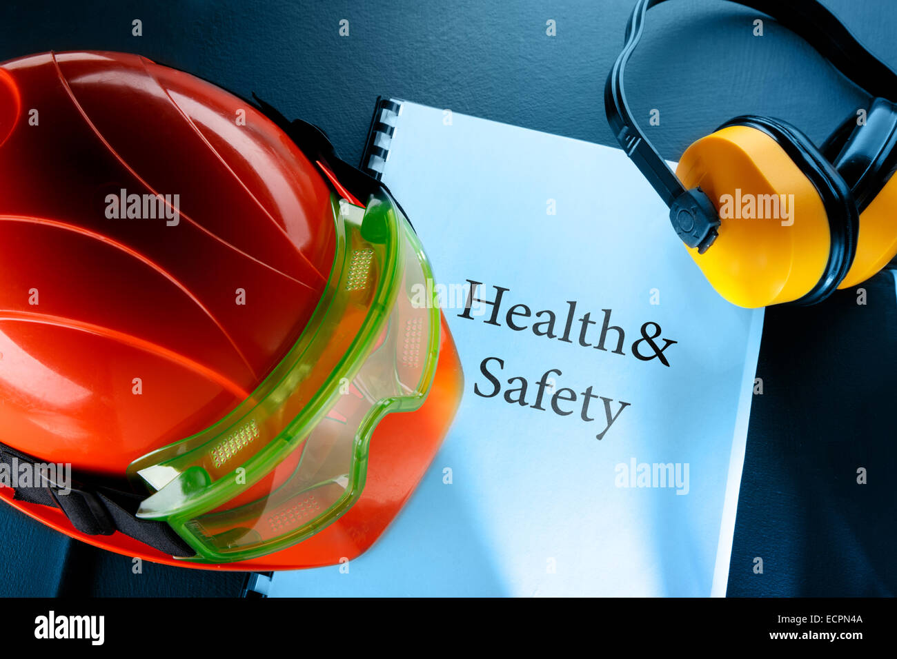 Safety goggles, earphones and red helmet in closeup Stock Photo