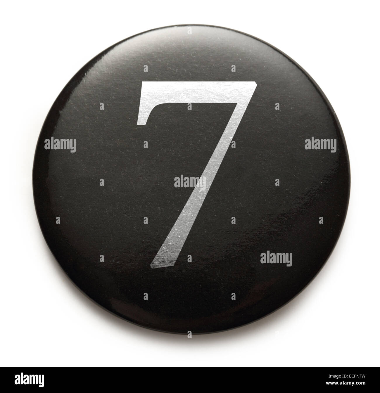 White number 7 on black round badge Stock Photo