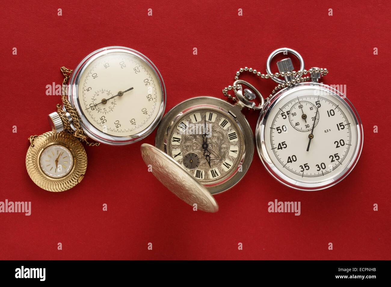 Pocket vintage watch and stopwatch on red Stock Photo