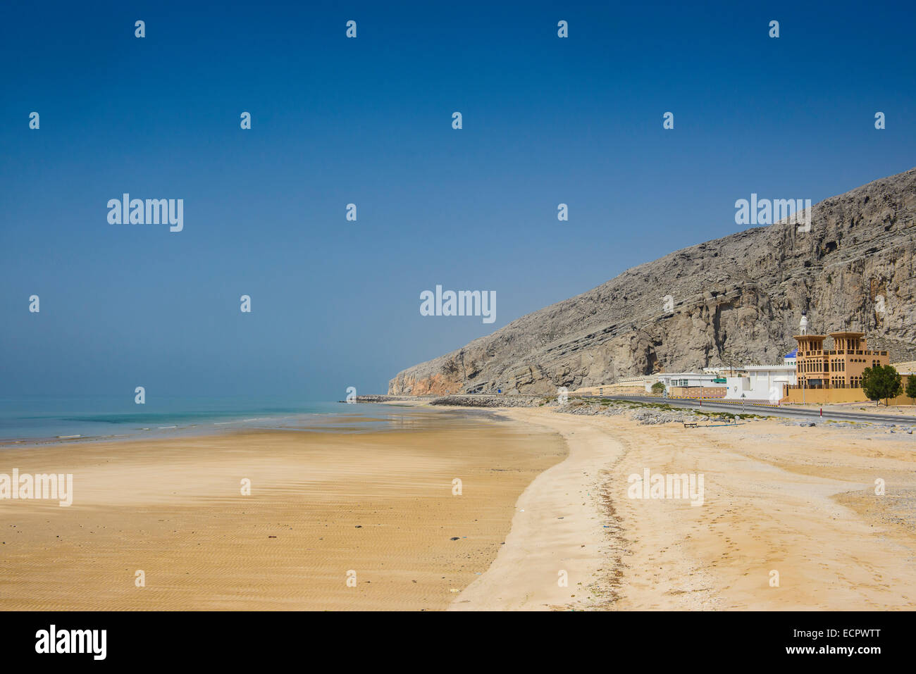 Long sandy beach along the Khasab coastal road, Musandam, Oman Stock Photo