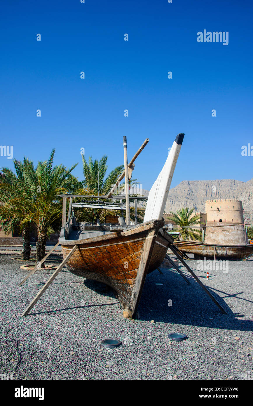 Old dhow in front of Khasab fort, Khasab, Musandam, Oman Stock Photo