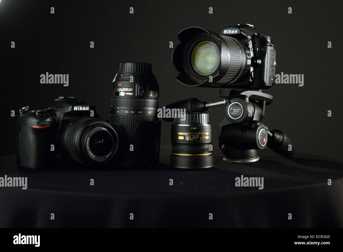 Cameras Nikon D90, Nikon d7000, lenses on black background Stock Photo