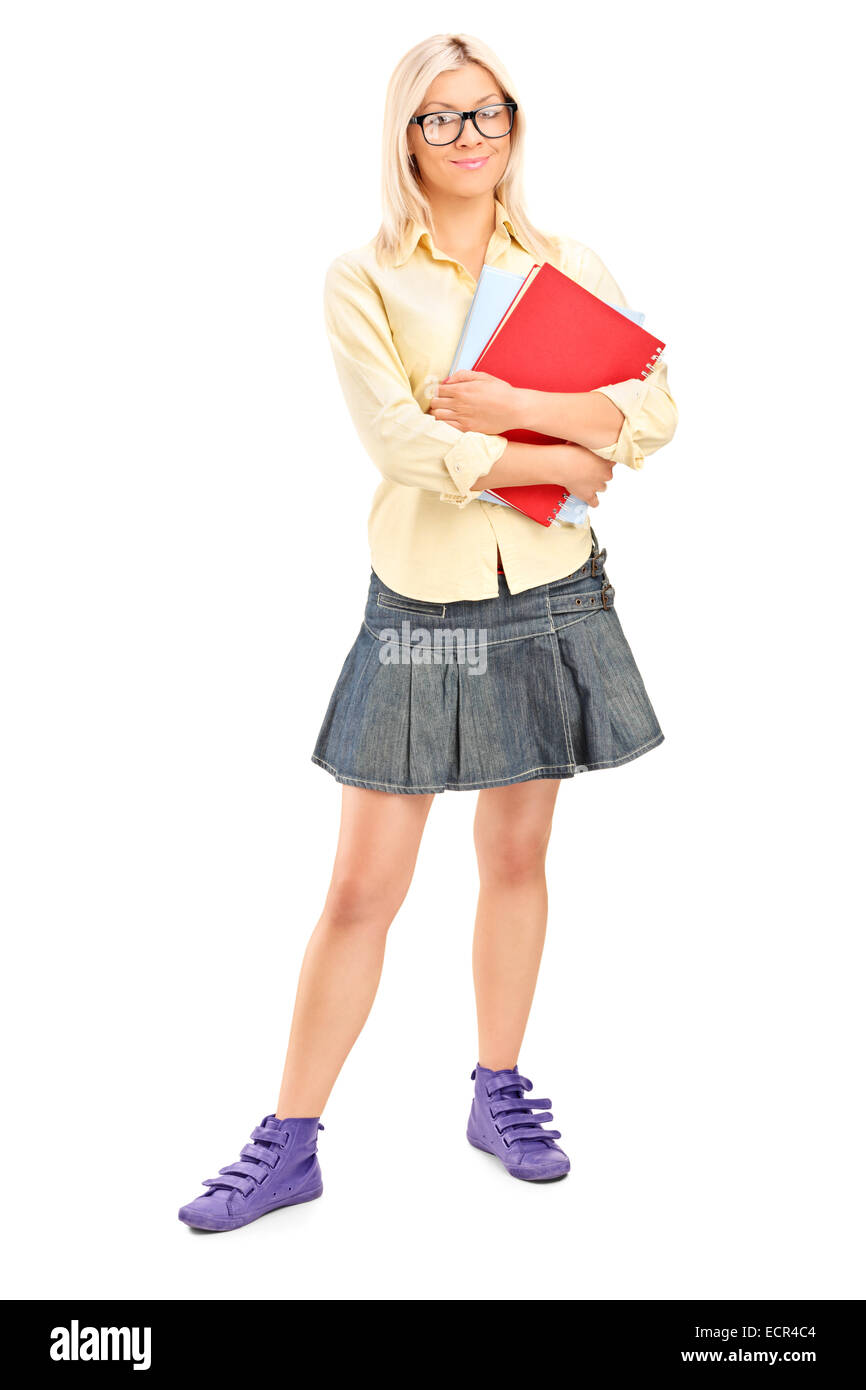 Full length portrait of a pretty female student holding books isolated ...