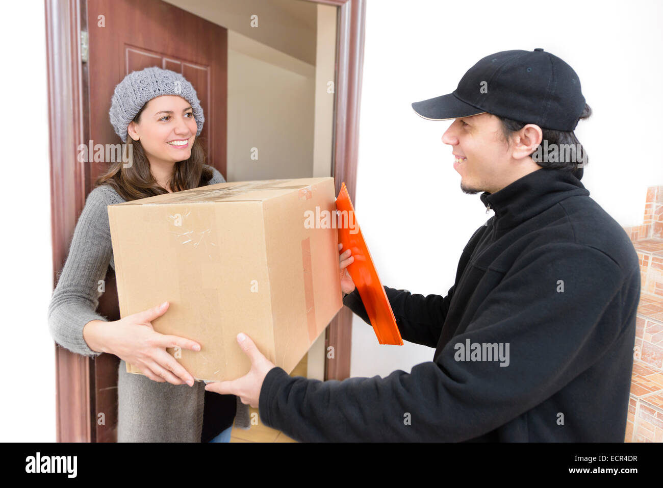 Courier Delivering a Package to a happy woman Stock Photo