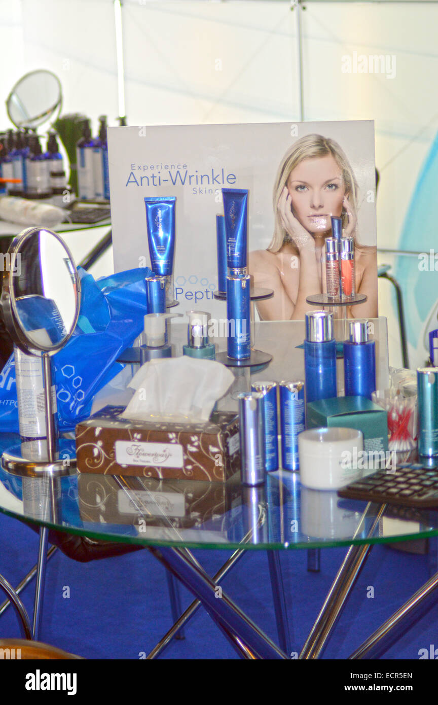 Intercharm XII International Perfumery and Cosmetics Exhibition Moscow Autumn Glass coffee table with means for body care. Stock Photo