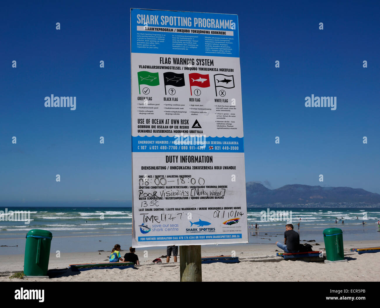 Public safety information sign about shark spotting on the beach front
