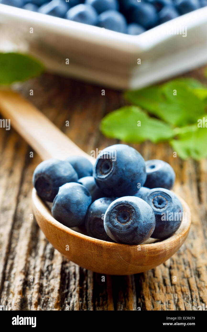 Ripe blueberries on a wooden spoon Stock Photo