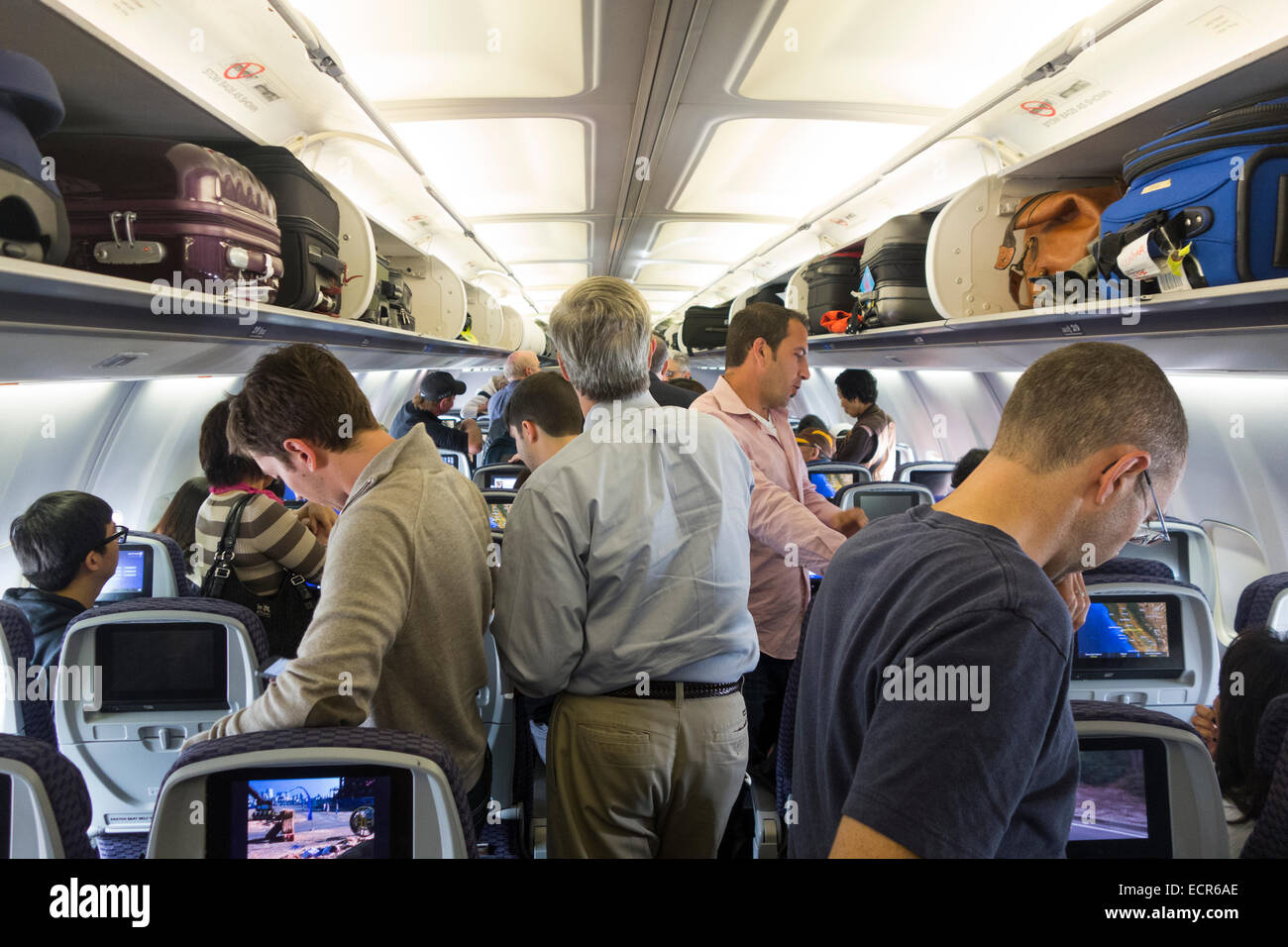 passengers on United Airlines airplane JFK airport Stock Photo