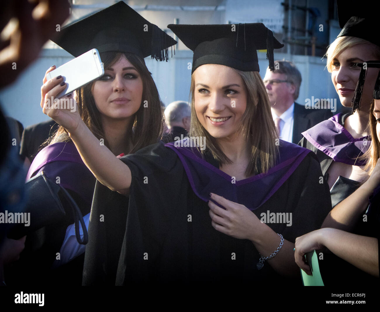 Two female graduates taking a selfie before the graduation ceremony of Southampton Solent University in Guildhall Square. Stock Photo