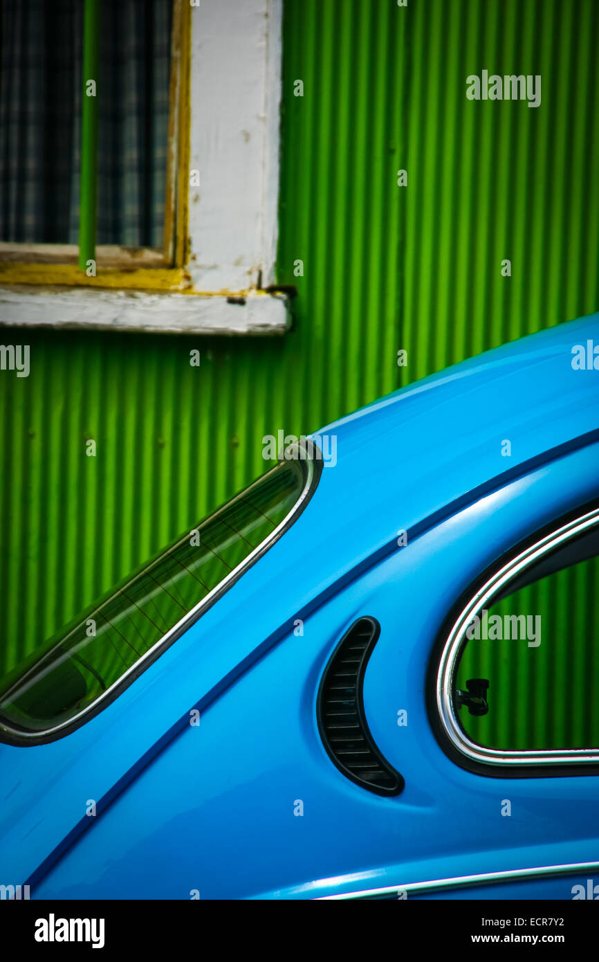Bright blue volkswagen beetle in front of a green house in Valparaiso Chile, South america Stock Photo