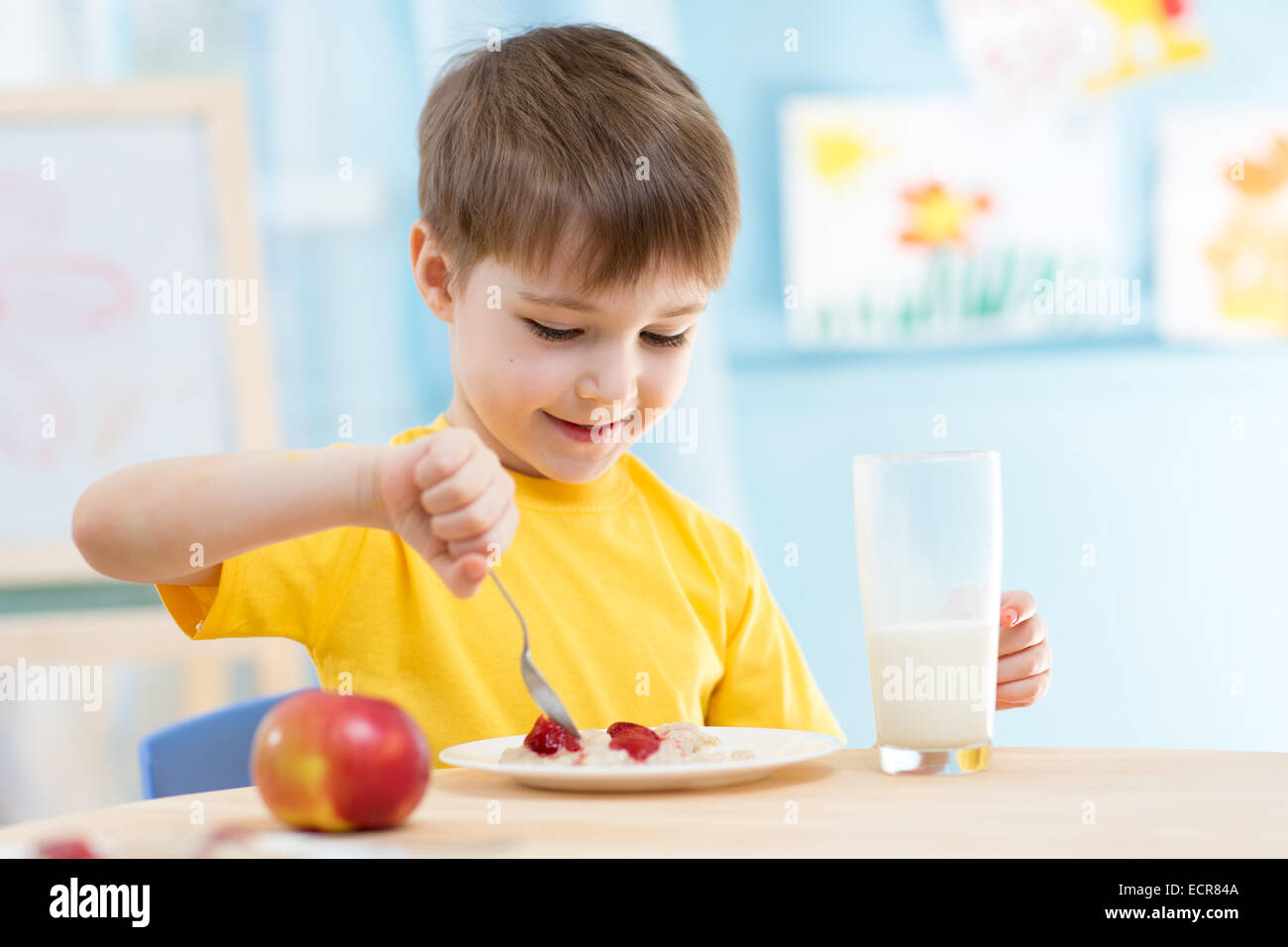 kid eating healthy food at home Stock Photo