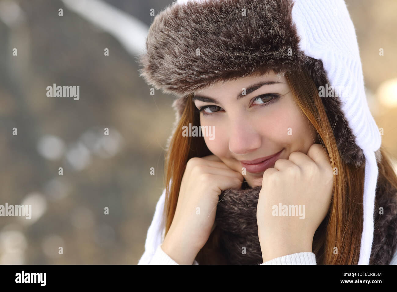 Beauty woman face portrait warmly clothed in winter holding a scarf outdoors Stock Photo