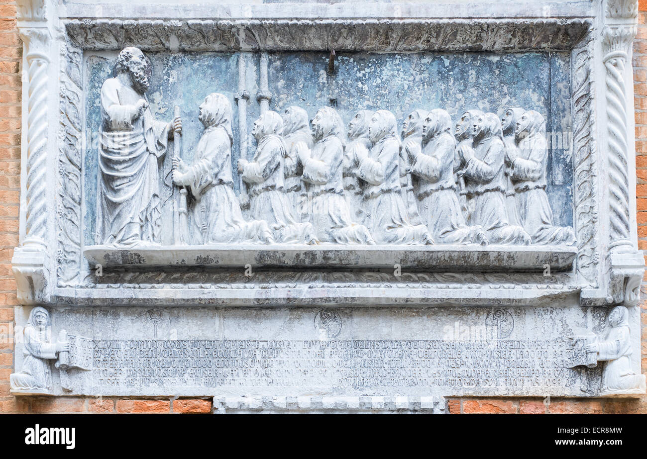 Stone sculpture of eager students and their teacher outside a disused school at Venice, Italy. Stock Photo