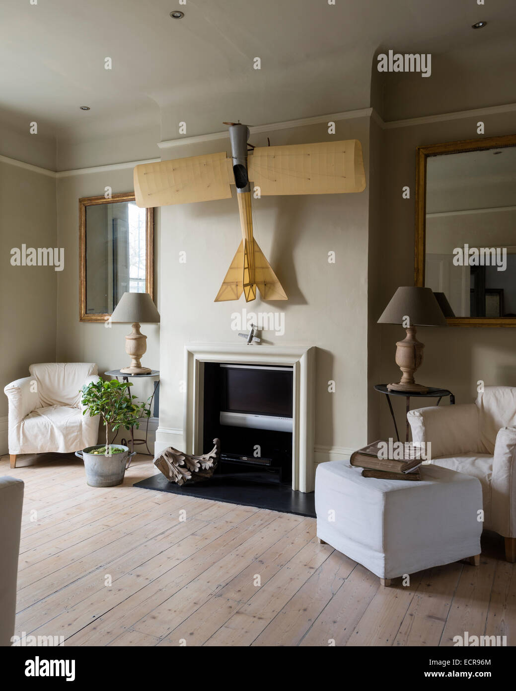Large Scale Model Airplane Hung Above Fireplace In Spacious Living