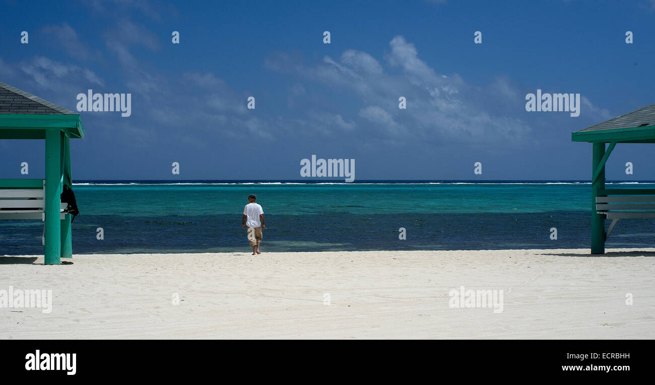 Man walking on a beach in the Caribbean Stock Photo - Alamy