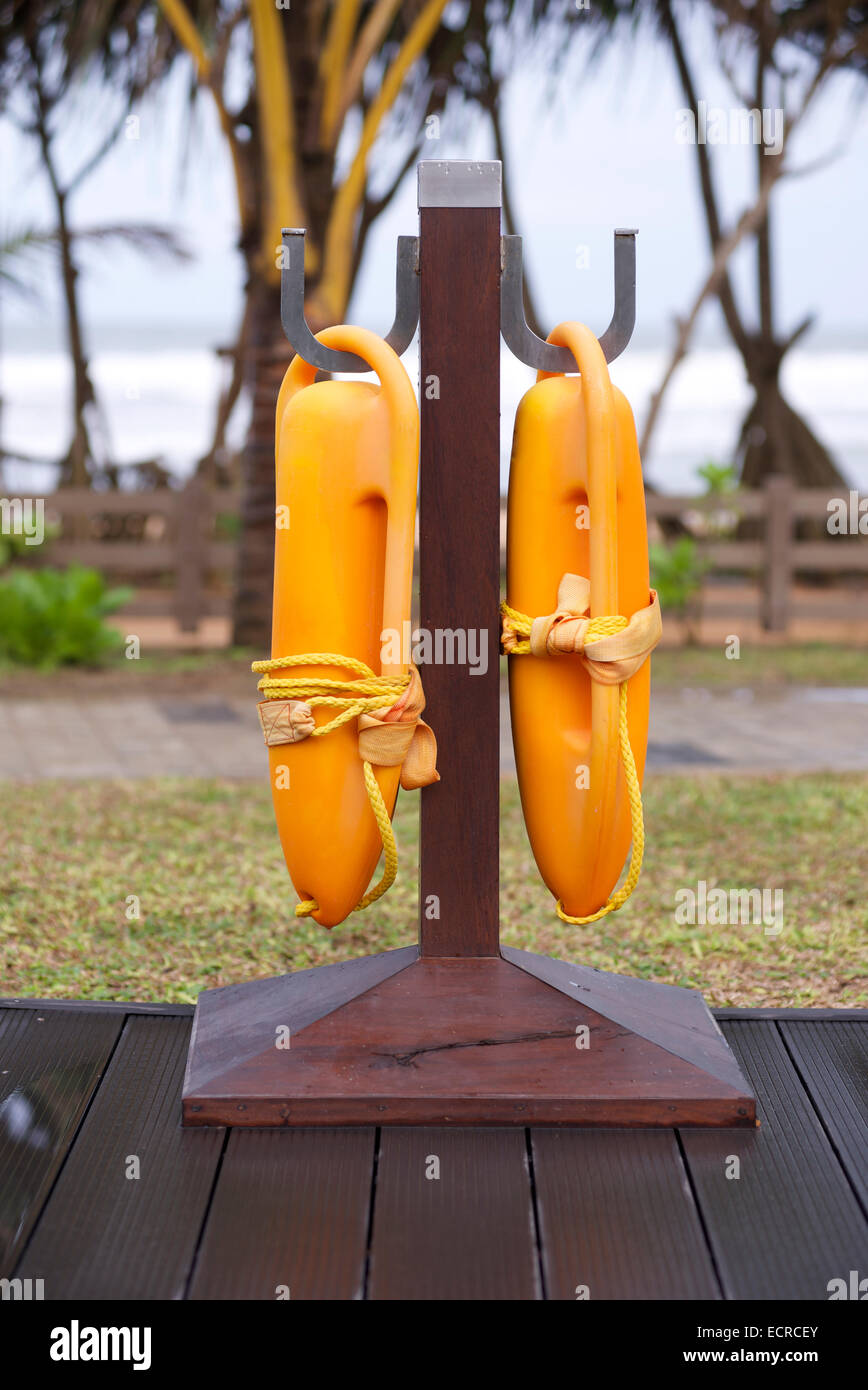 pair of orange life buoys hanging on hooks Stock Photo