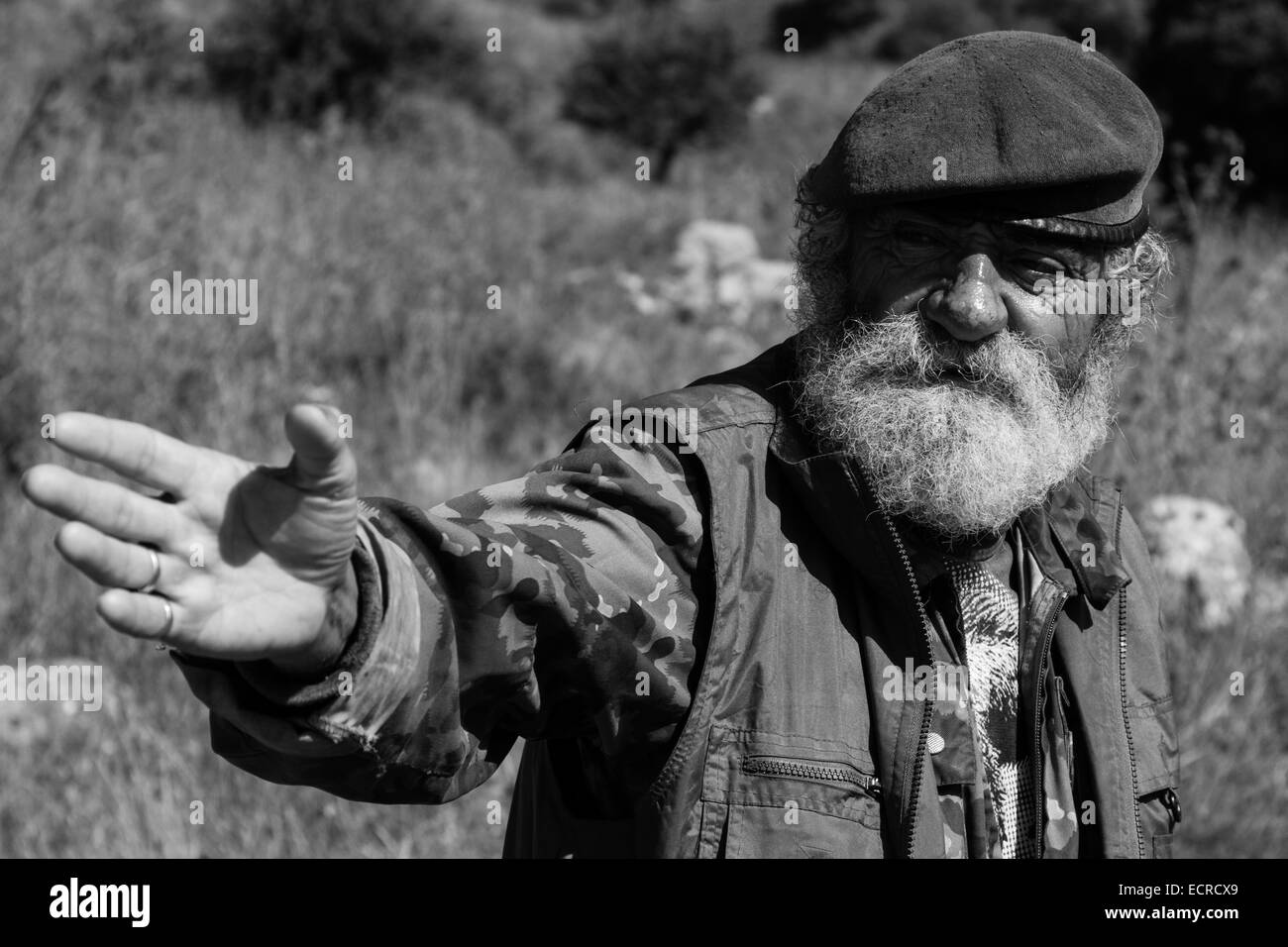 That is the way, seems to say this old man, somewhere in the mainland of Peloponnese, Greece. Stock Photo