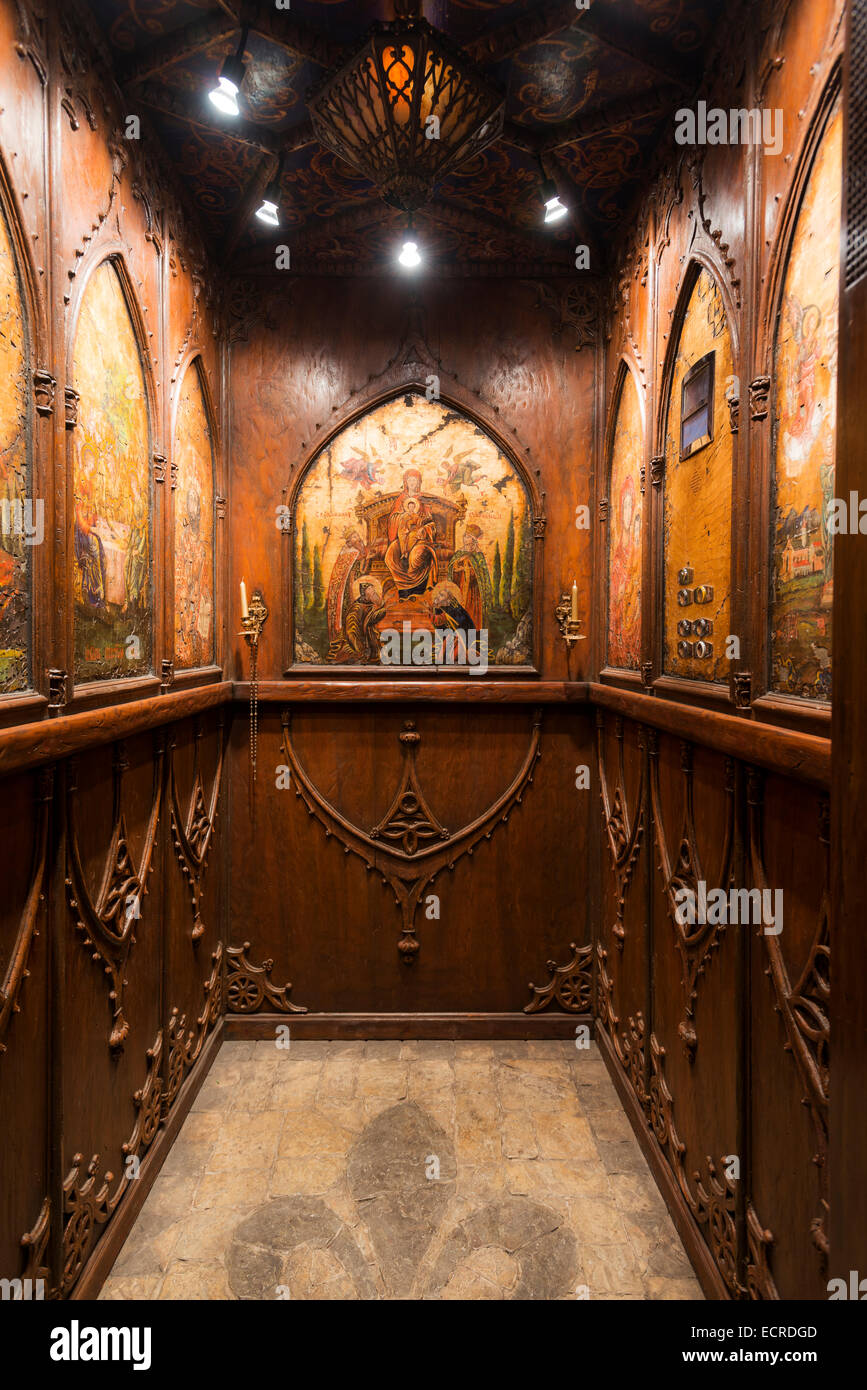 Wood panelled elevator with coffered ceiling and biblical imagery Stock Photo