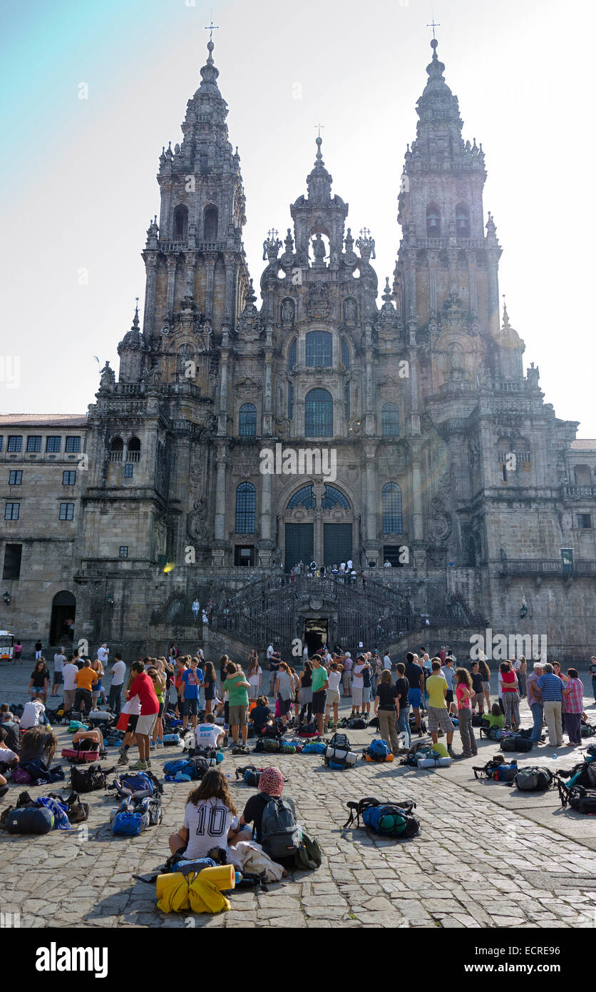 SANTIAGO DE COMPOSTELA, SPAIN – SEPTEMBER 8, 2012: Pilgrims rest on end the Camino de Santiago in the Obradoiro Square after rea Stock Photo