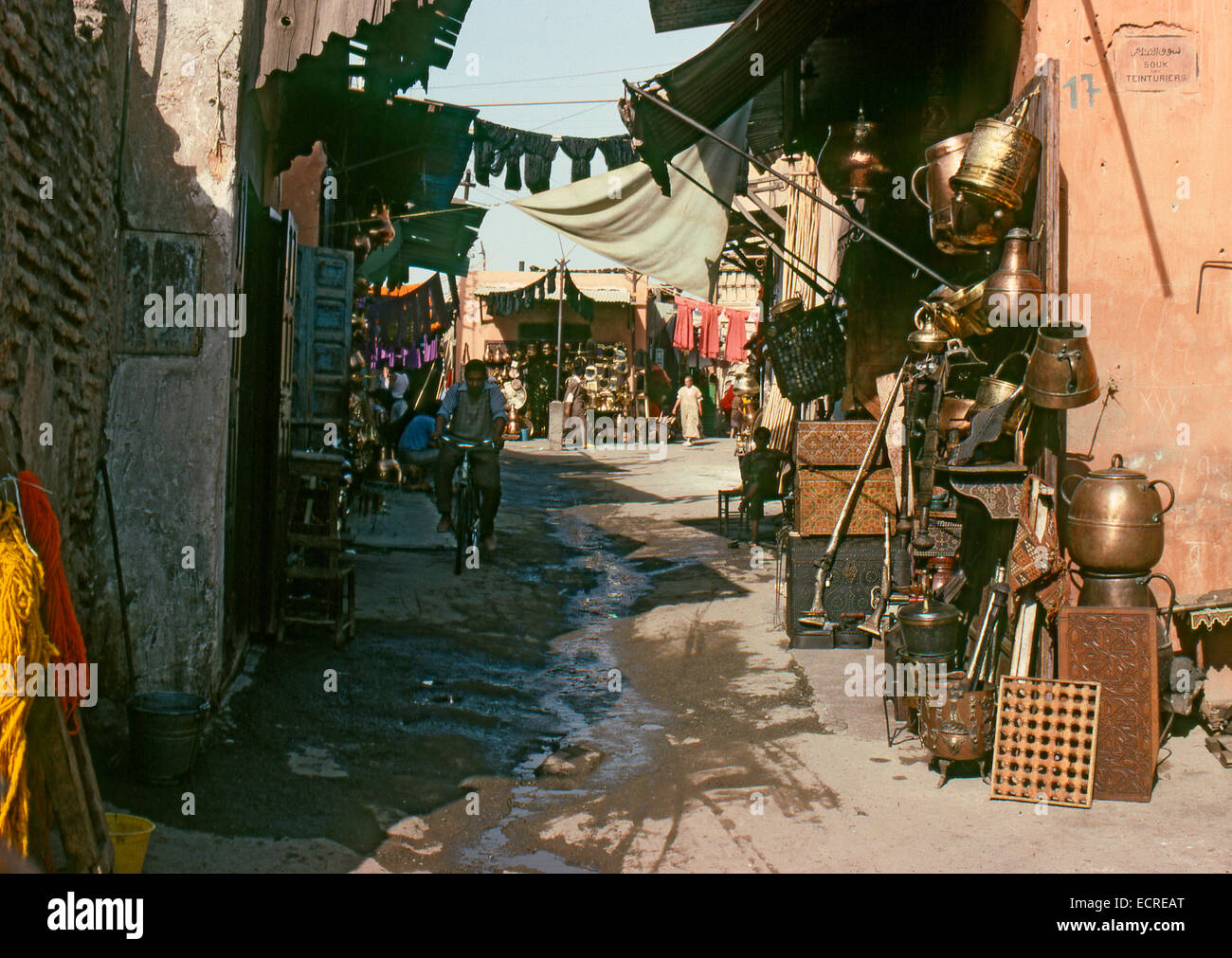 MARRAKECH, MOROCCO – AUGUST, 1979: People walking down a shopping street in the medina of a North African city on August, 1979 i Stock Photo