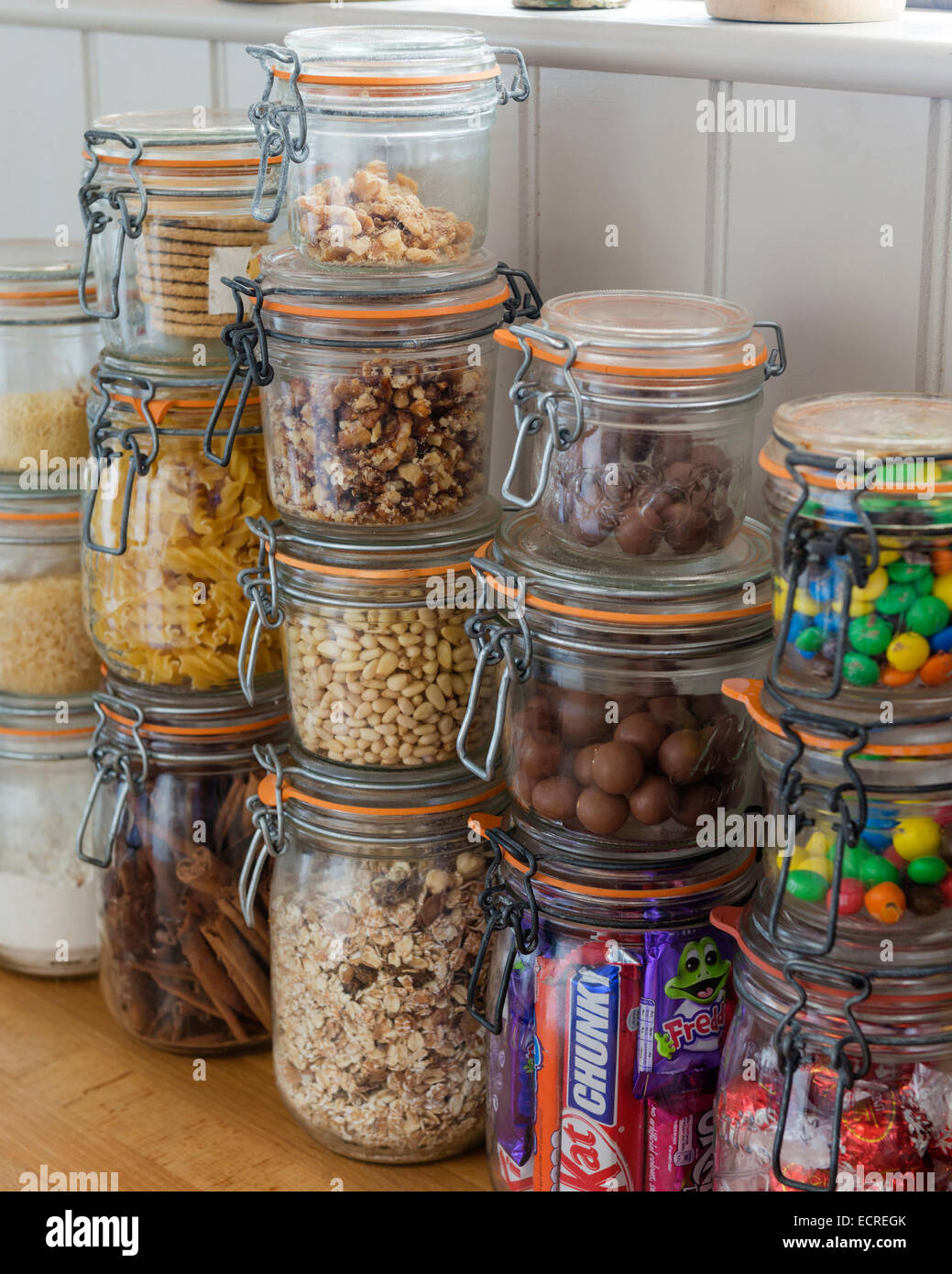 Assorted dried foods and chocolates in stacked kilner jars Stock Photo