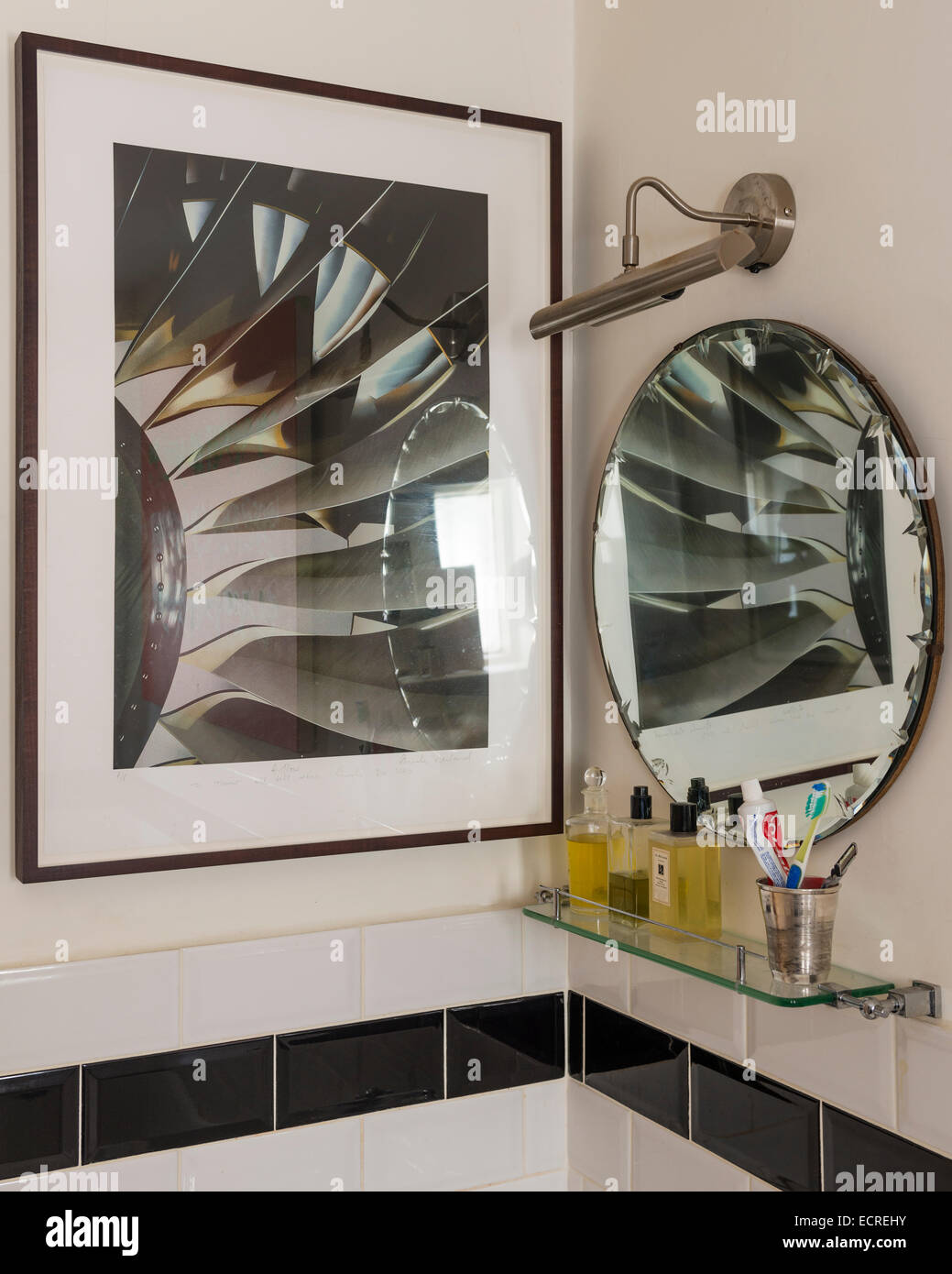 Brendan Neiland photograph on bathroom wall with circular mirror Stock Photo