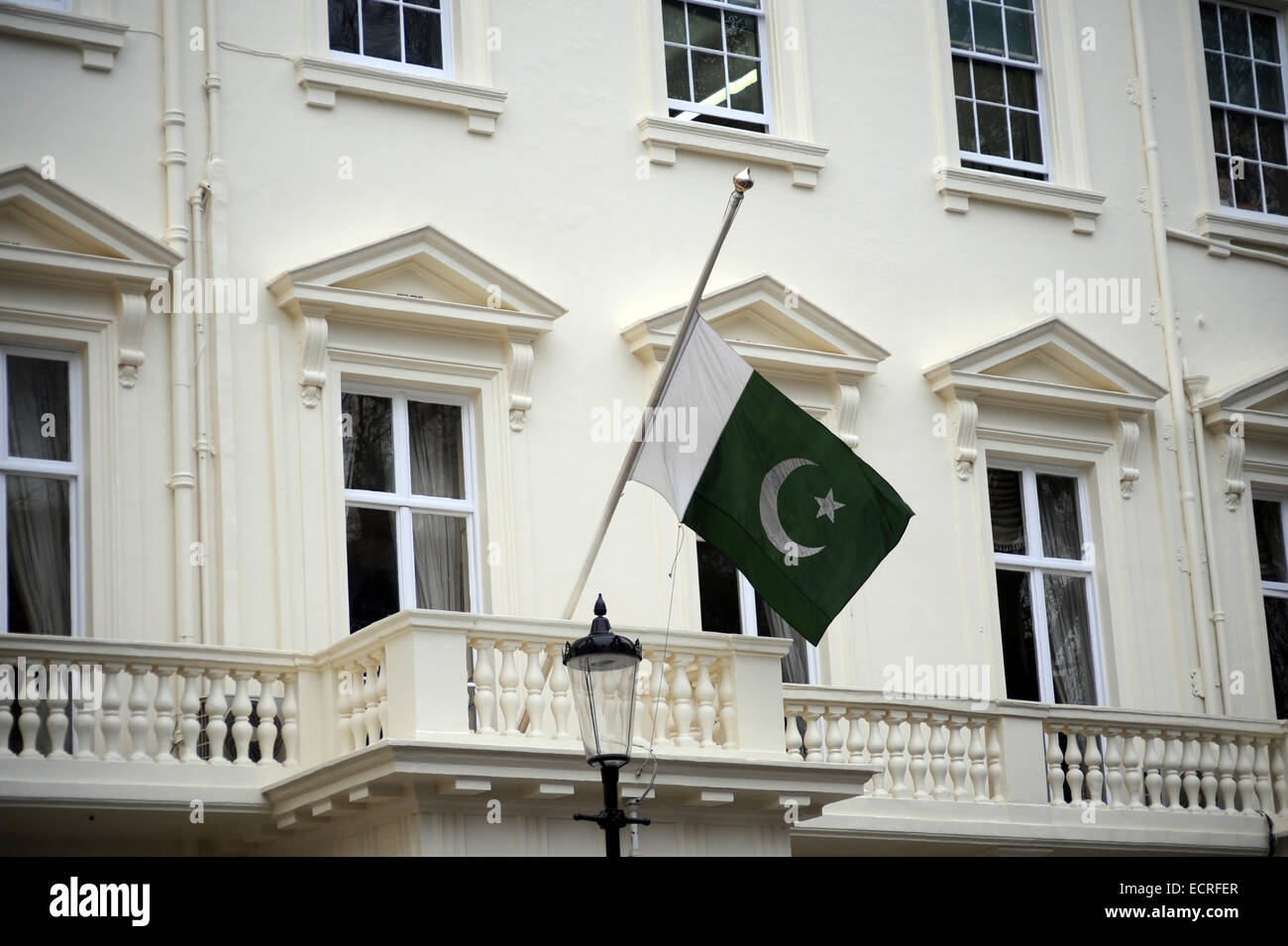 London, UK, 18 December 2014, The Pakistan Embassy in London flies its flag at half-mast in the 3 days of mourning following the Peshawar school massacre. Credit:  JOHNNY ARMSTEAD/Alamy Live News Stock Photo