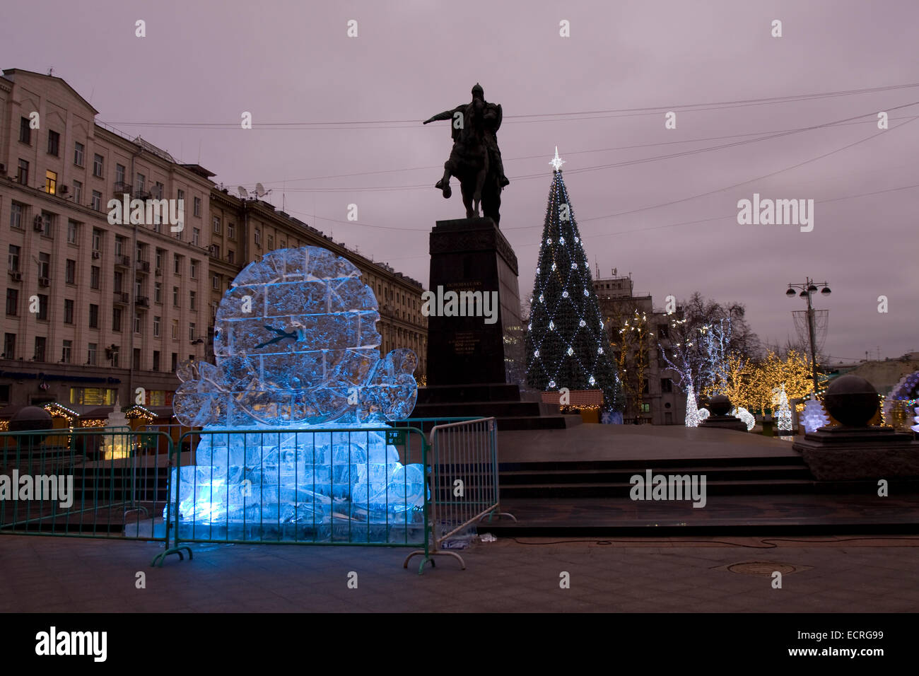 MOSCOW - DECEMBER 26, 2013: Ice clock and Christmas tree on Tverskaya street near monument to king Yuriy Dolgorukiy. Stock Photo