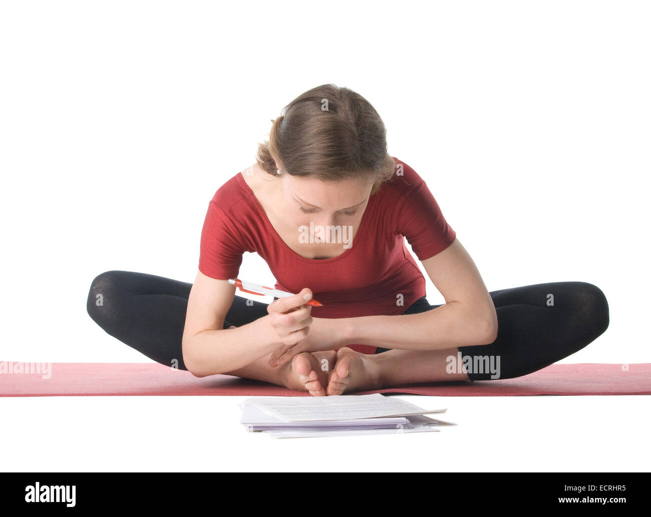 Young woman in sports clothes working with documents Stock Photo