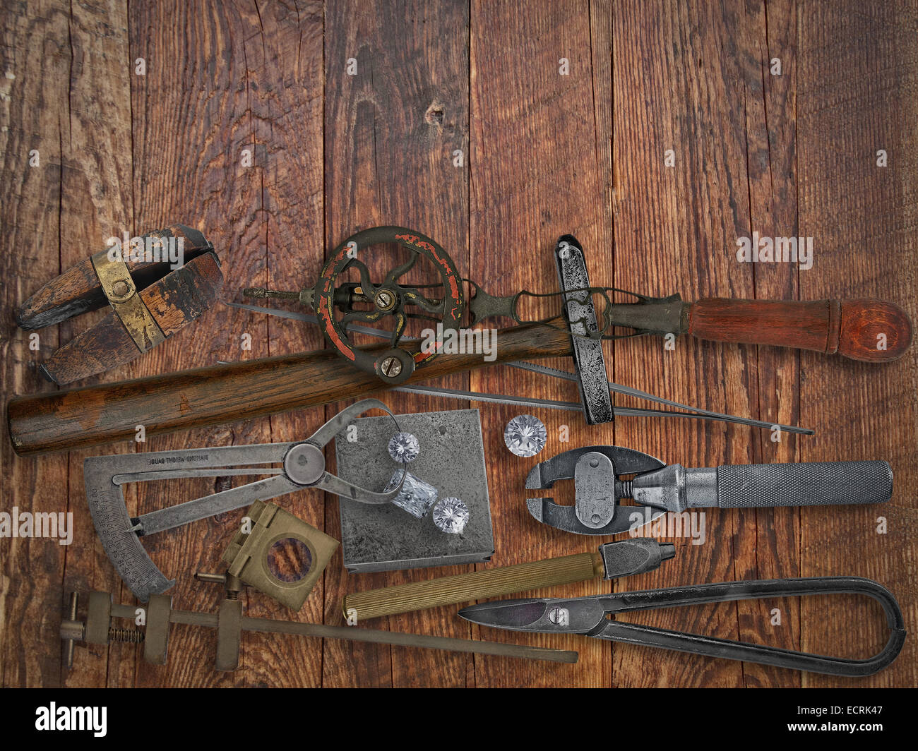 vintage jeweler tools and diamonds over wooden working bench, space for text Stock Photo