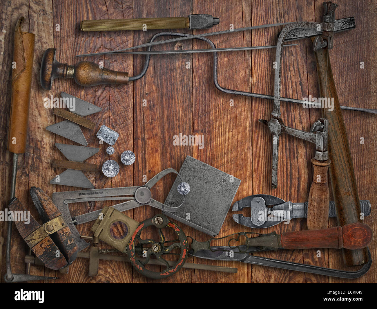 vintage jeweler tools and diamonds over wooden working bench, space for