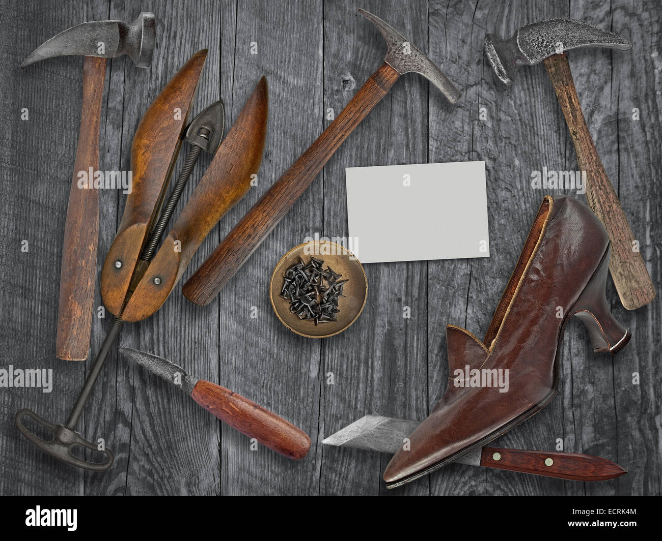 vintage ladies shoe and shoemakers tools over wooden table, space for your text on a blank business card Stock Photo