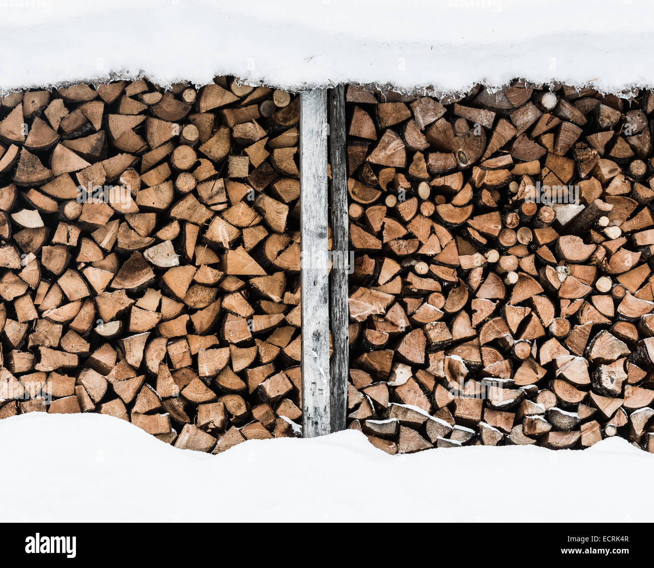 Cut logs stacked in the winter Stock Photo