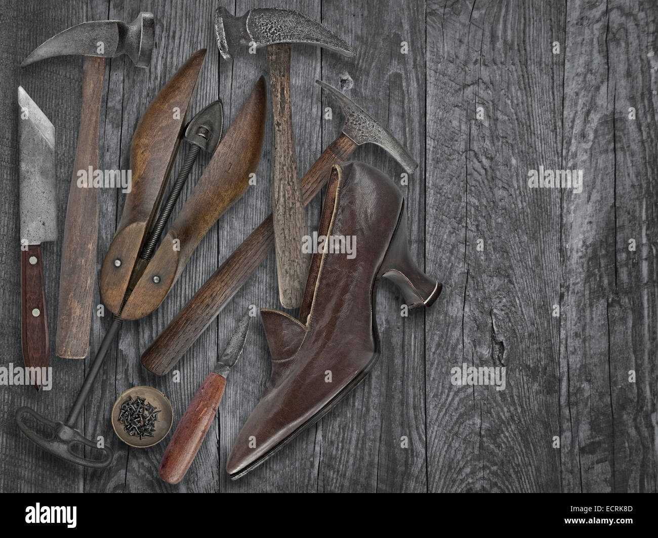 vintage ladies shoe and shoemakers tools over wooden table, space for your trxt Stock Photo