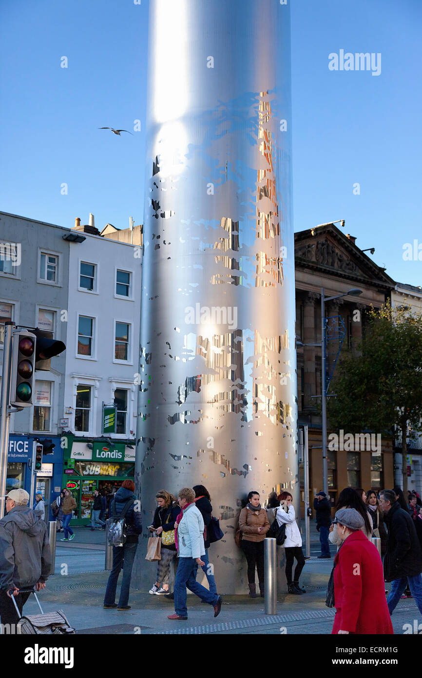 Ireland, Dublin, O'Connell Street, People standing at the base of the Spire sculpture. Stock Photo