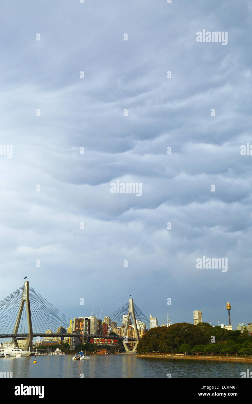 Clouds roll in ahead of a thunderstorm over ANZAC Bridge in Rozelle Bay, Sydney, NSW, Australia. Stock Photo