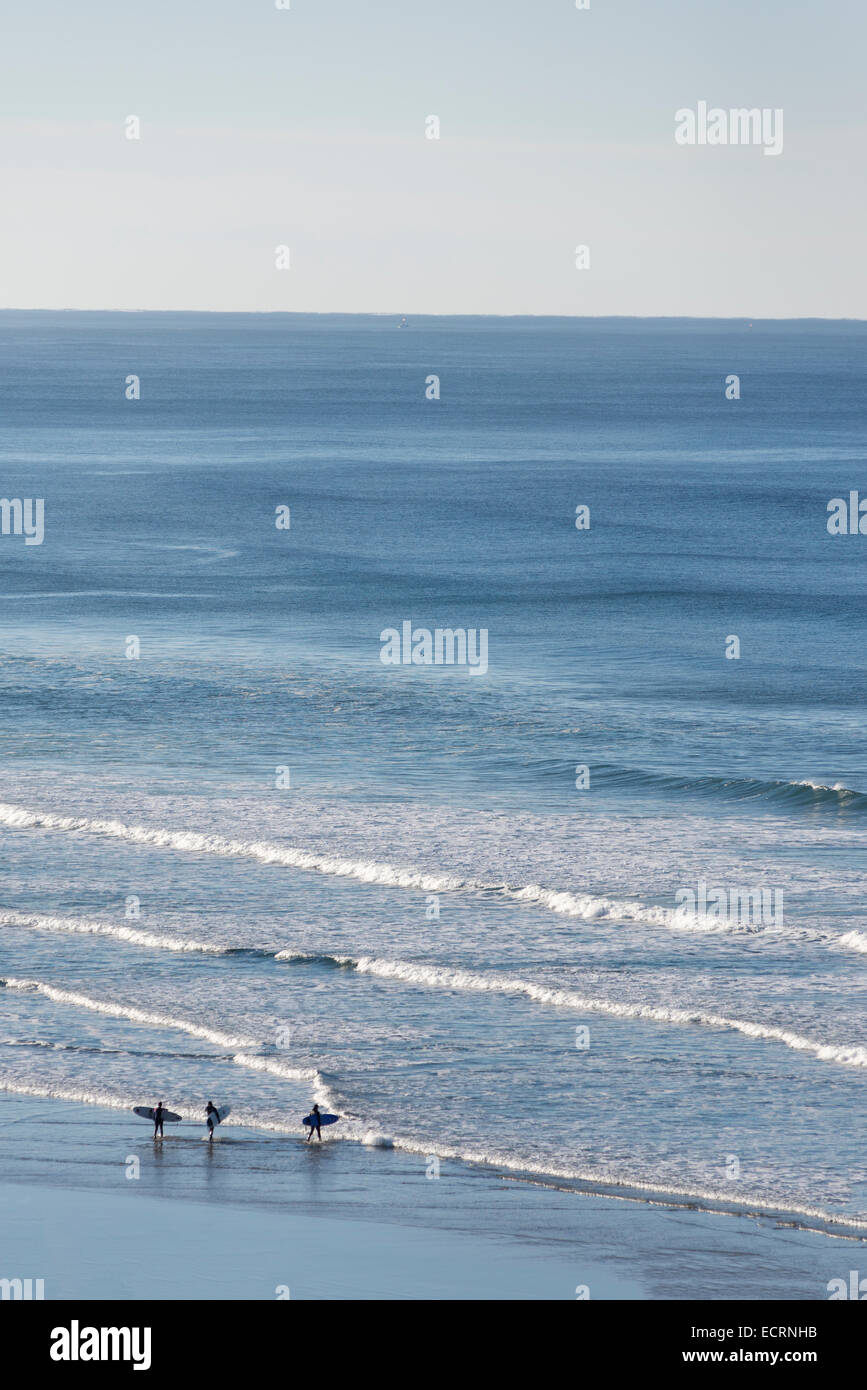 Surfers heading out from Agate Beach on the Oregon Coast. Stock Photo