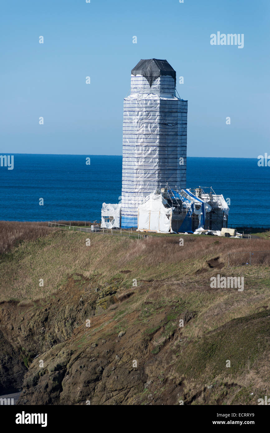 Yaquina Head Lighthouse, on the Oregon coast, covered with scaffolding and a plastic cover for maintenance work. Stock Photo