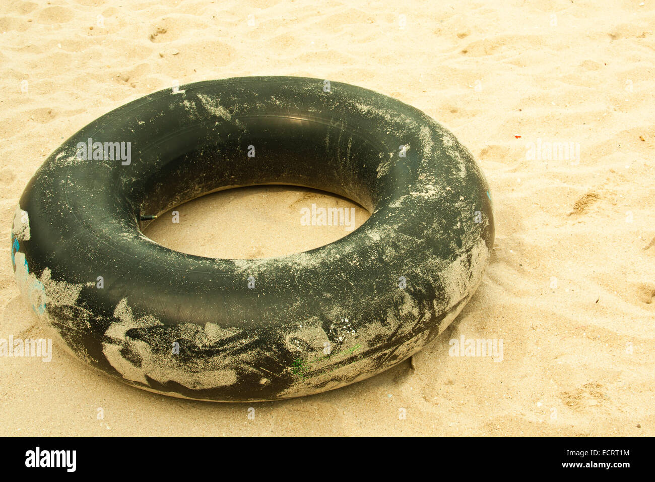 Old inner tube of car wheels on sand background Stock Photo Alamy