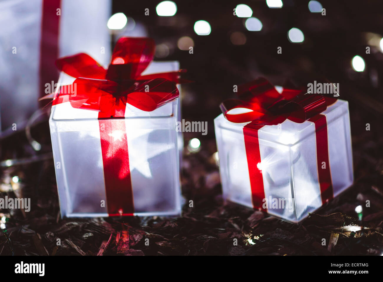 Glowing Christmas gifts under tree Stock Photo