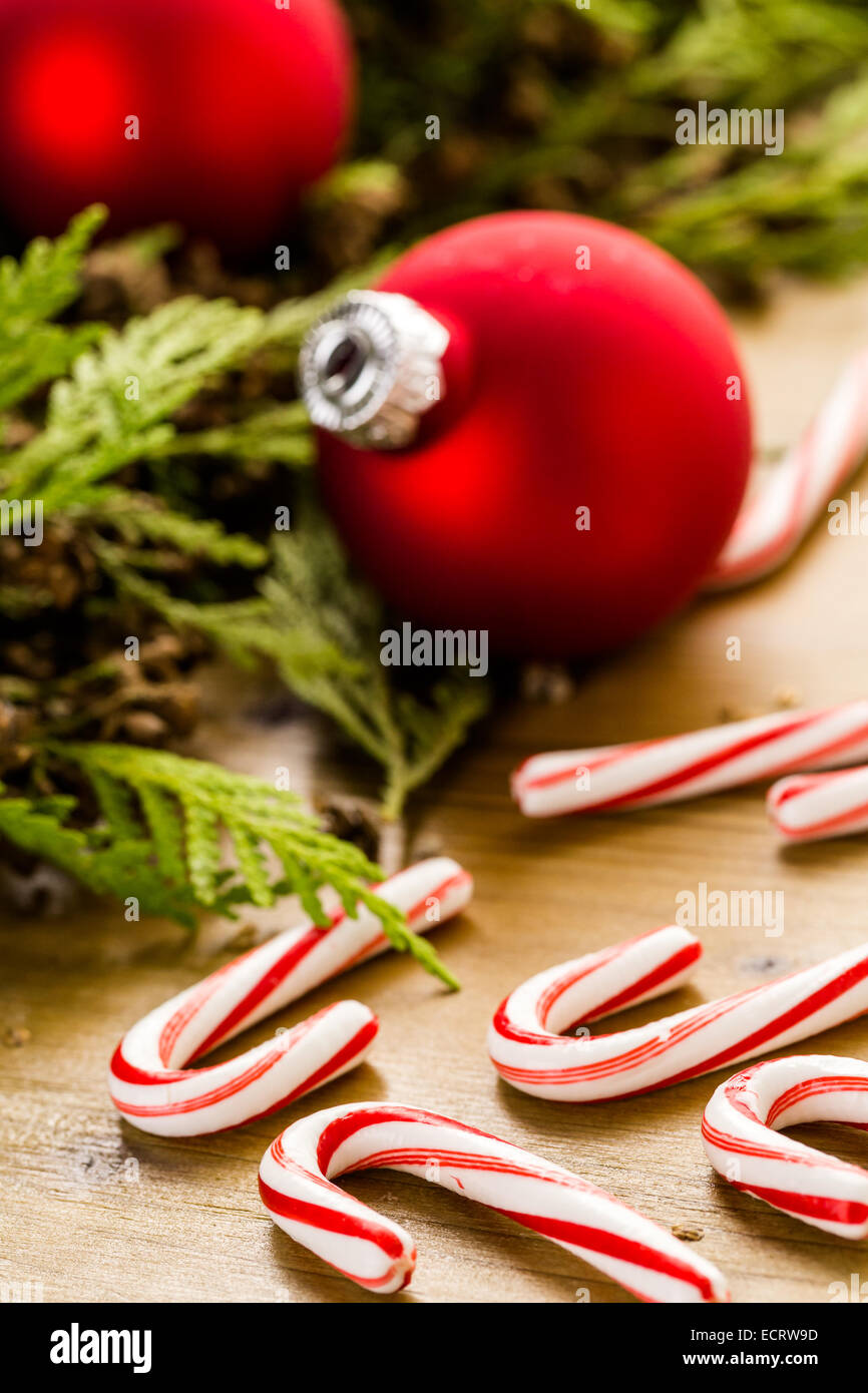 Red Christmas ornaments on stained wood table. Stock Photo