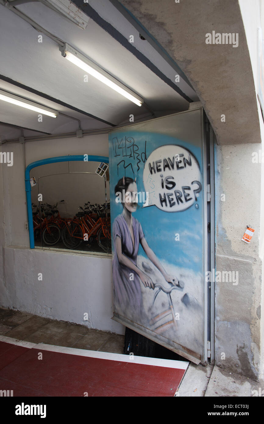 Open door with mural to a bicycle shop and service in Barcelona