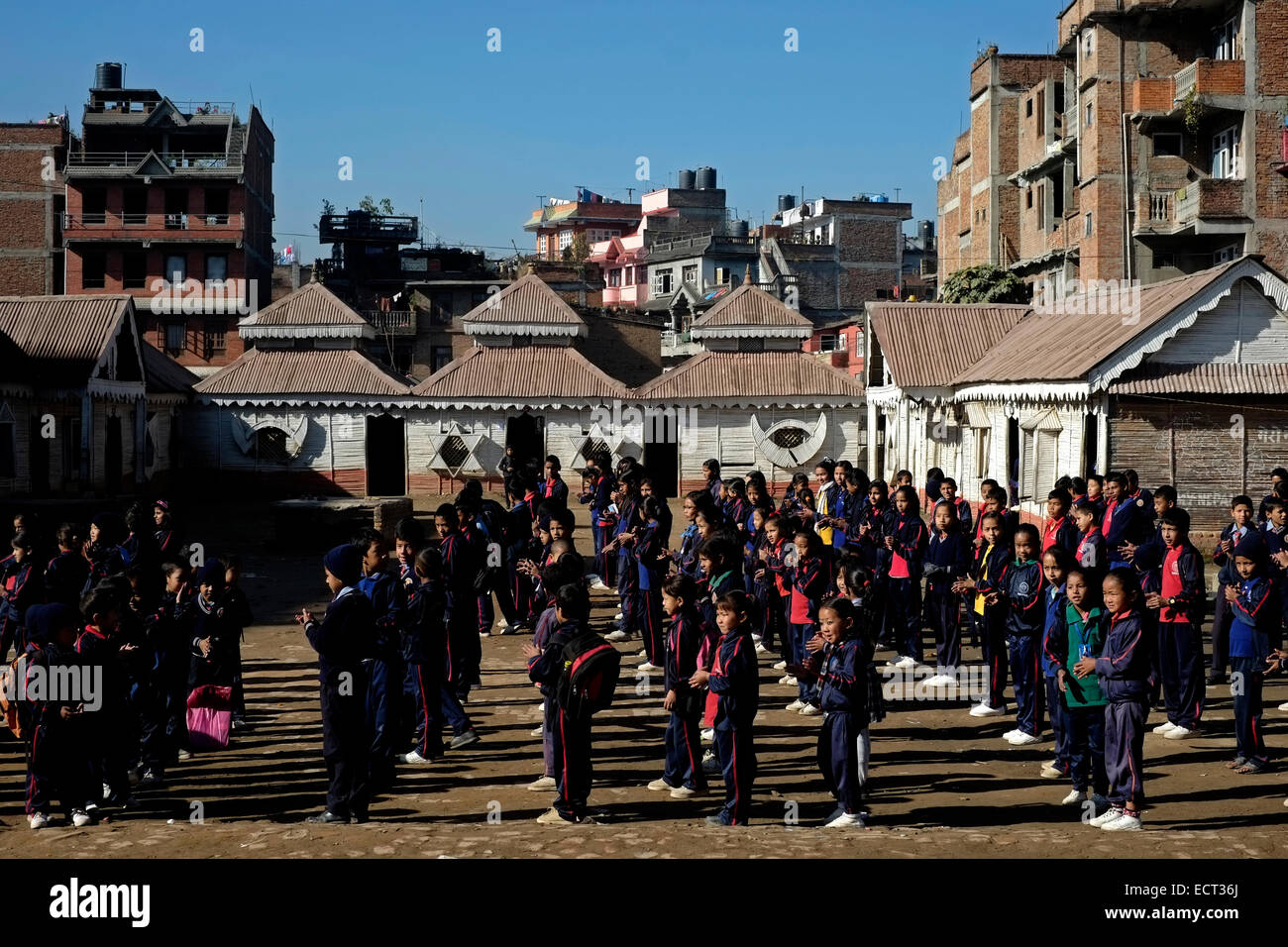 Schoolchildren standing in formation for morning assembly in school yard of Samata Shiksha Niketan elementary school which cost just 100 Nepali Rupees ($1.35) per student each month in the city of Bhaktapur Also known as Khwopa in Nepal Stock Photo