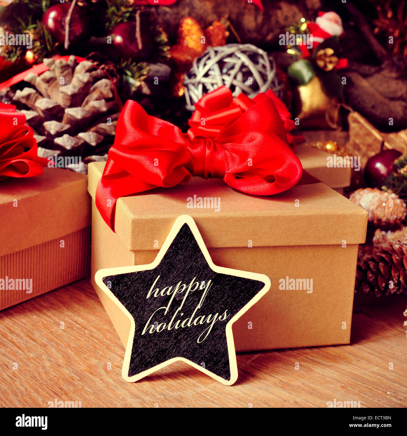 the text happy holidays written in a star-shaped chalkboard with some gifts and a pile of different christmas ornaments, such as Stock Photo