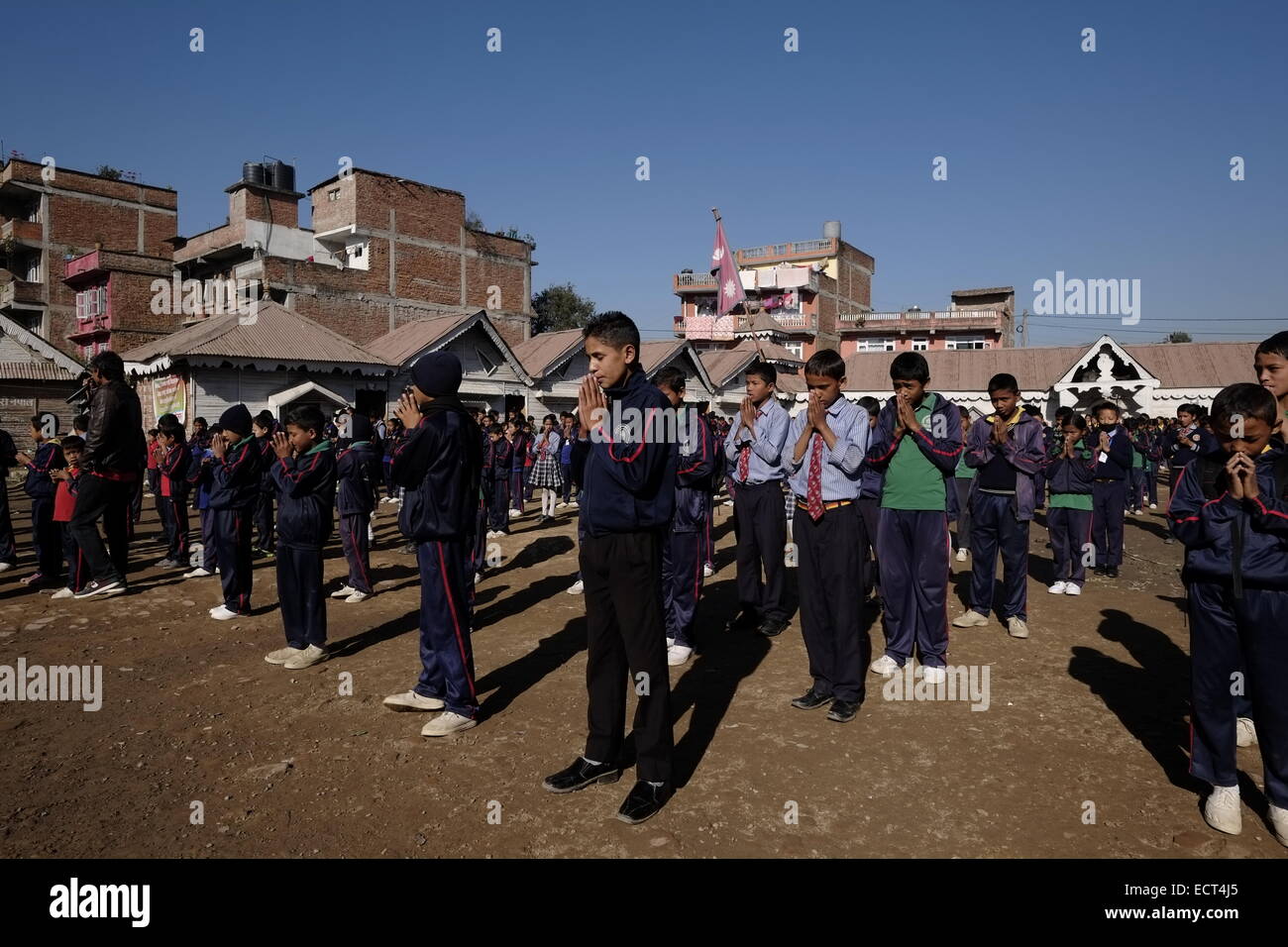 Schoolchildren standing in formation for morning assembly in school yard of Samata Shiksha Niketan elementary school which cost just 100 Nepali Rupees ($1.35) per student each month in the city of Bhaktapur Also known as Khwopa in Nepal Stock Photo