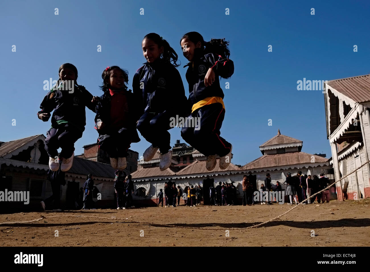Schoolgirls practicing Double Dutch jump rope in the school yard of Samata Shiksha Niketan elementary school which cost just 100 Nepali Rupees ($1.35) per student each month in the city of Bhaktapur Also known as Khwopa in Nepal Stock Photo