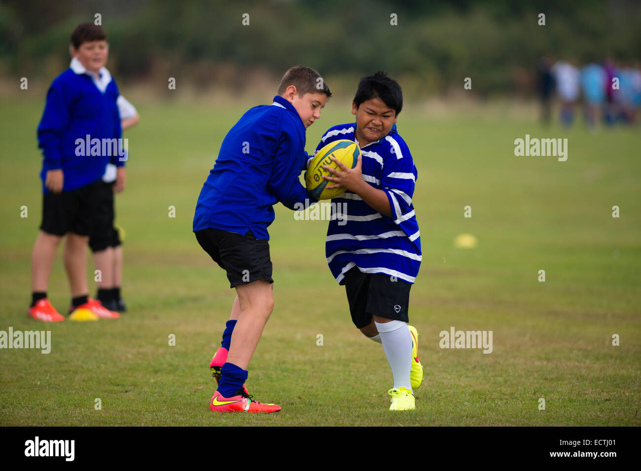 Secondary school PE - physical education Wales UK: games lesson - young teenage boys playing rugby rugger outdoors on a sports field pitch ground Stock Photo