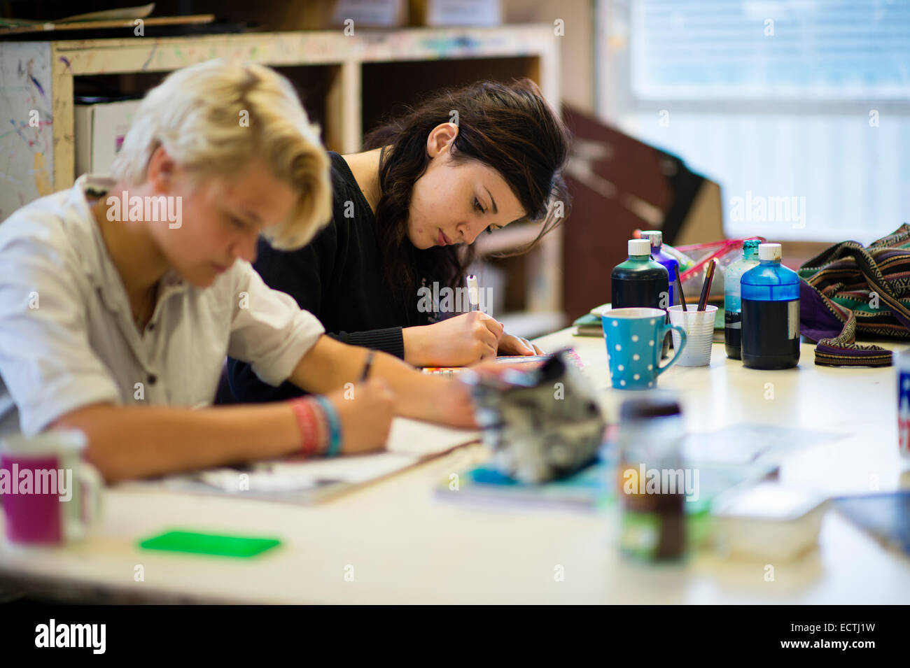 Secondary school education Wales UK: two year 12 teenage girls working  drawing in an A Level  art class lesson Stock Photo