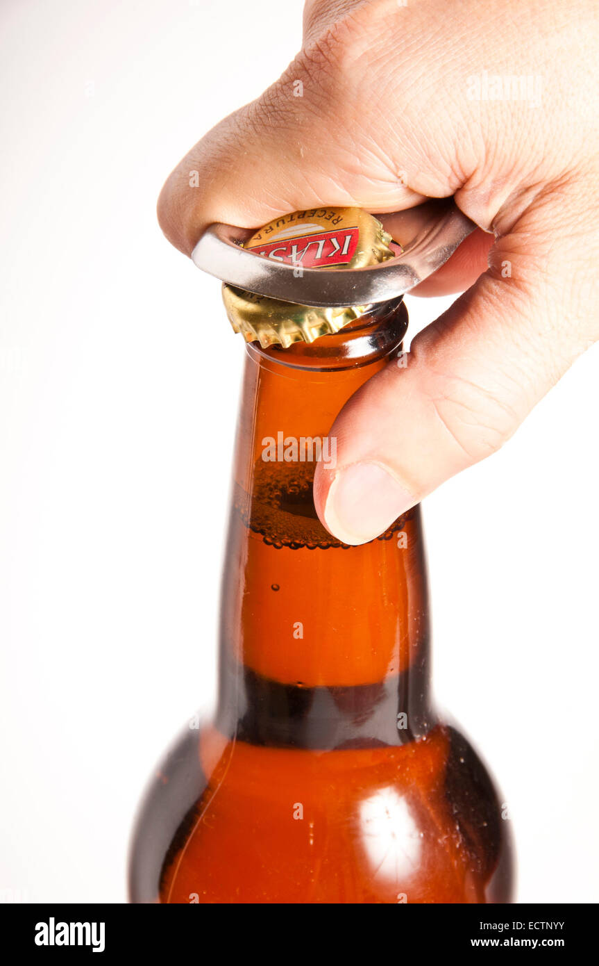 hand opening a beer bottle Stock Photo