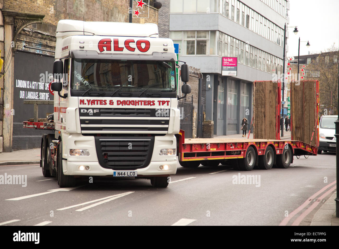 LONDON - NOVEMBER 25TH: A long alco truck navigates a sharp corner on November the 25th, 2014, in London, England, UK. ALCO Filt Stock Photo